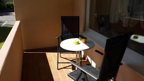 a small white table and chairs on a balcony at Ferienwohnung Sayer-Roth in Bad Krozingen