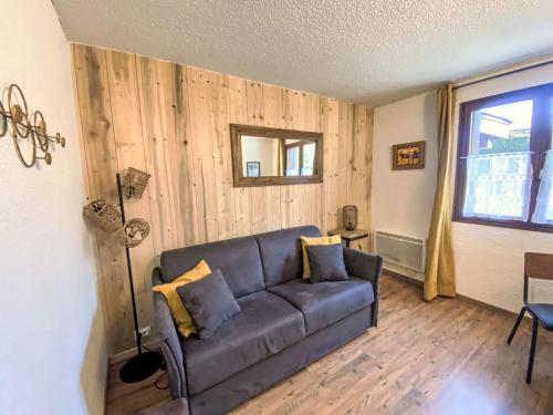 un salon avec un canapé et une fenêtre dans l'établissement Apartment Le Choucas by Interhome, à Chamonix-Mont-Blanc