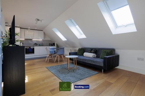 a living room with a couch and a table at One Bedroom Apartment By Arhouse Apartments Short Lets & Serviced Accommodation Kingston With Free WiFi in Kingston upon Thames