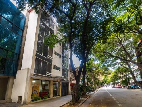 an empty street in front of a building at Capital O Hotel Suites Marne, Mexico City in Mexico City