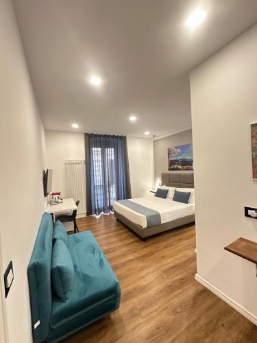 a bedroom with a bed and a couch in a room at Sweet Rooms in La Spezia