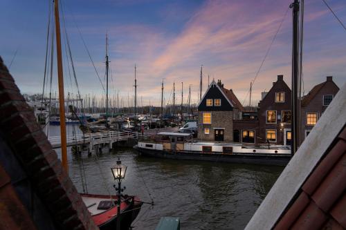 a group of boats docked at a marina at Apartment at the harbor in Monnickendam