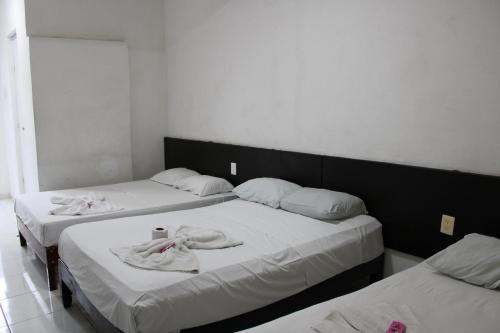 Postel nebo postele na pokoji v ubytování OYO Hotel Colibri