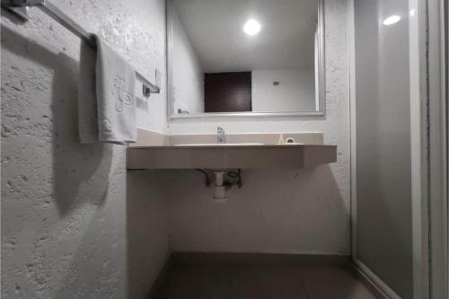 a bathroom with a sink and a mirror at Hotel Del Portal, Puebla in Puebla