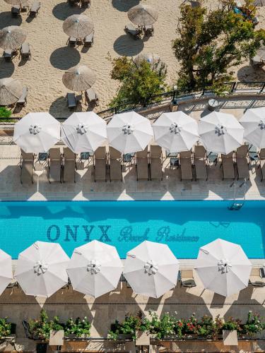 an overhead view of tables with white umbrellas at Onyx Beach Residence - Free Parking & Beach Access in Sveti Vlas