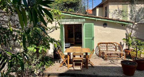 a table and chairs in front of a house at Hotel Le Ponteil in Antibes