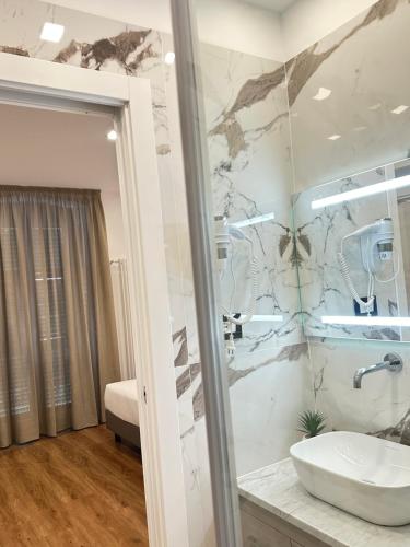 a bathroom with a sink and a shower at Sweet Rooms in La Spezia