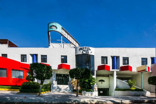 a building with a roller coaster on top of it at Capital O Hotel Casa Blanca, Morelia in Morelia