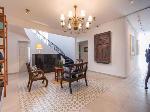 a living room with chairs and a chandelier at Collection O Hotel Lavanda Anzures in Mexico City