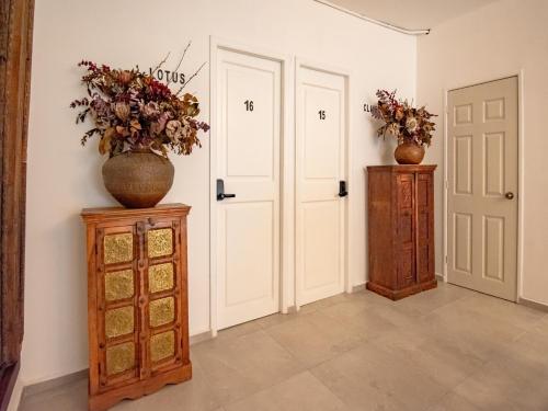 two vases sitting on top of cabinets in a room at Collection O Hotel Lavanda Anzures in Mexico City