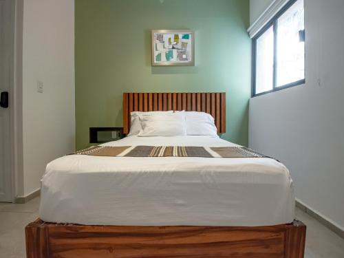 a large bed in a room with a window at Collection O Hotel Lavanda Anzures in Mexico City