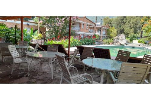 a group of tables and chairs next to a swimming pool at Capital O Posada Del Pescador Jocotepec in Chapala