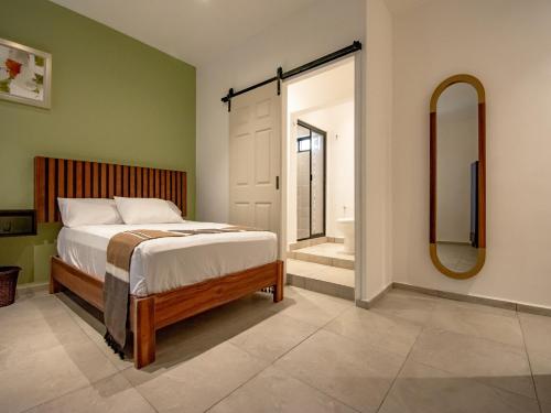 a bedroom with a bed and a mirror and a tub at Collection O Hotel Lavanda Anzures in Mexico City