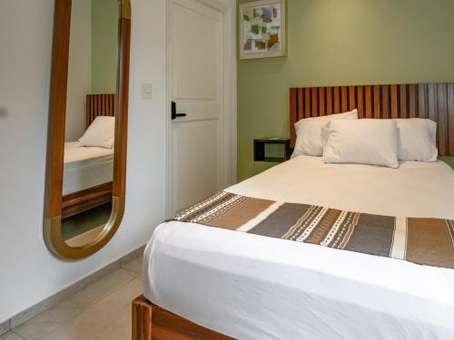 a bedroom with a bed and a mirror at Collection O Hotel Lavanda Anzures in Mexico City