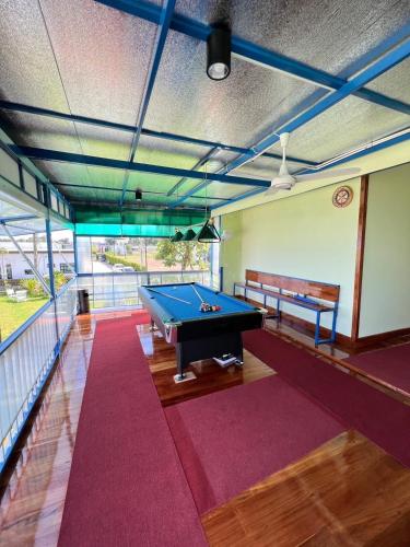 a billiard room with a pool table and a balcony at Baan Thammarot View in Sirindhorn