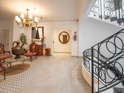 a hallway with a staircase and a living room at Collection O Hotel Lavanda Anzures in Mexico City