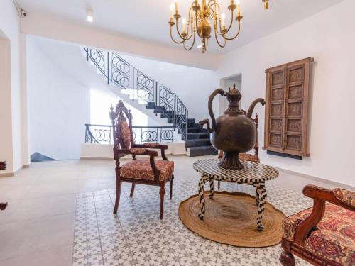 a living room with two chairs and a vase on a table at Collection O Hotel Lavanda Anzures in Mexico City