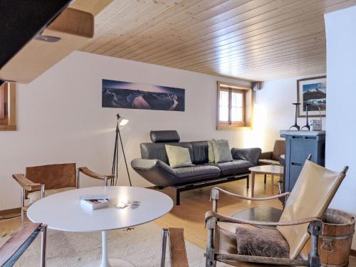 a living room with a couch and a table at Chalet Wätterlücke by Interhome in Wengen