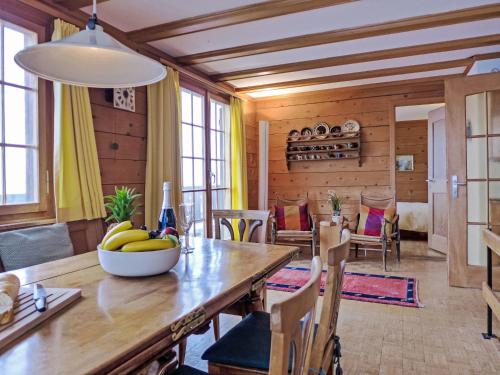 a dining room with a table with bananas on it at Chalet Wätterlücke by Interhome in Wengen