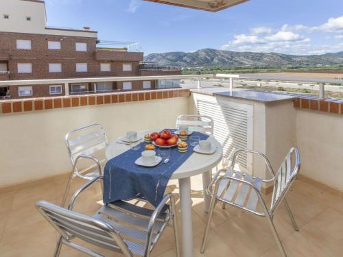 a table and chairs with a bowl of fruit on a balcony at Apartment Playa Coral I-1 by Interhome in Oropesa del Mar