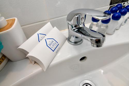 a bathroom sink with toilet paper and a faucet at By The Sea - central with free parking in Varna City