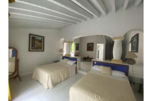 a bedroom with two beds in a room at Capital O Gran Hotel Campestre in Celaya