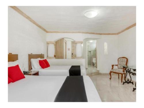 Postel nebo postele na pokoji v ubytování Capital O Gran Hotel Campestre