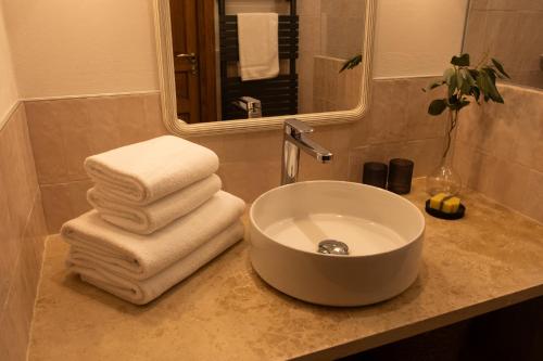 a bathroom with a sink and towels on a counter at Les Terrasses de la Borie in Mandagout