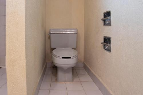 a bathroom with a white toilet in a stall at Collection O Hotel Mocambo, Boca del Río in Veracruz