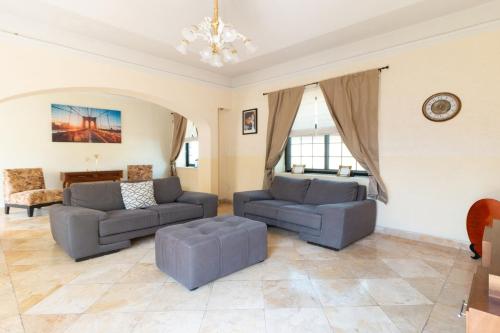 a living room with two couches and a couch at Capital O Hotel San Jose, San Luis Potosi in San Luis Potosí