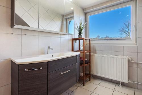 a bathroom with a sink and a window at Ferienwohnung Waldidyll in Wolgast