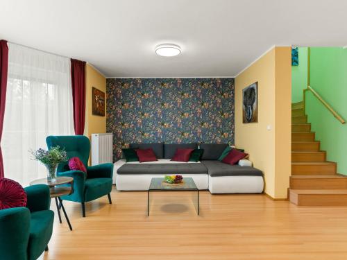 a living room with a couch and a staircase at Villa Garden & Terrace Villa by Interhome in Prague