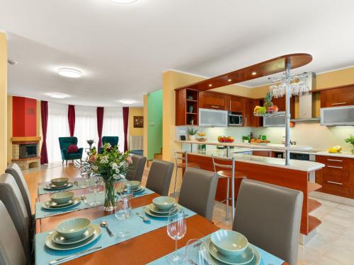 a dining room and kitchen with a table and chairs at Villa Garden & Terrace Villa by Interhome in Prague