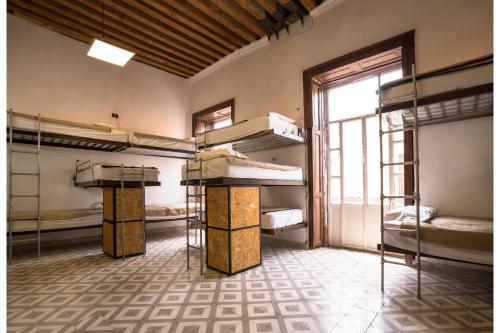a room with several bunk beds and a window at Casona Poblana Hotel Puebla in Puebla