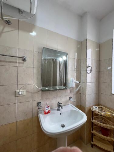 a bathroom with a sink and a mirror at Bellavista Qerret Apartments in Golem