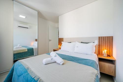 En eller flere senge i et værelse på Achei Itapema • 3 Quartos + Piscina e vista linda