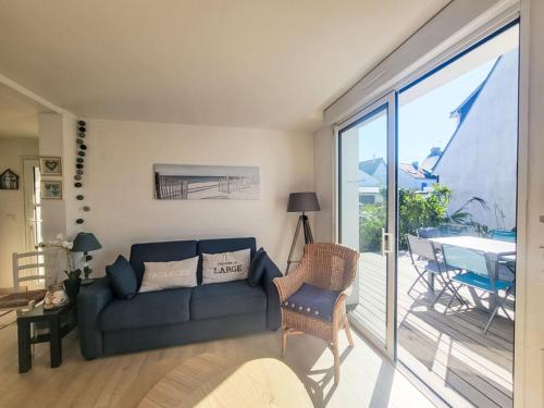 un salon avec un canapé et une porte coulissante en verre dans l'établissement Holiday Home Les Lutins by Interhome, à Carnac
