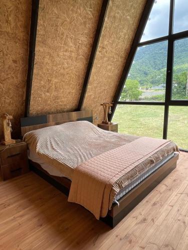 a large bed in a room with a large window at Holiday Home in Vǝndam