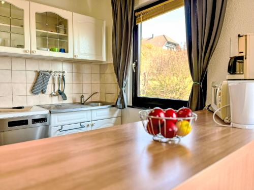 a kitchen with a bowl of apples on a counter at Holiday Home Hänsel & Gretel im Kellerwald by Interhome in Frankenau