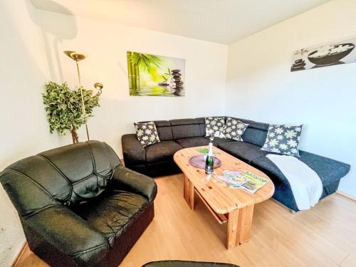 a living room with a couch and a table at Holiday Home Hänsel & Gretel im Kellerwald by Interhome in Frankenau