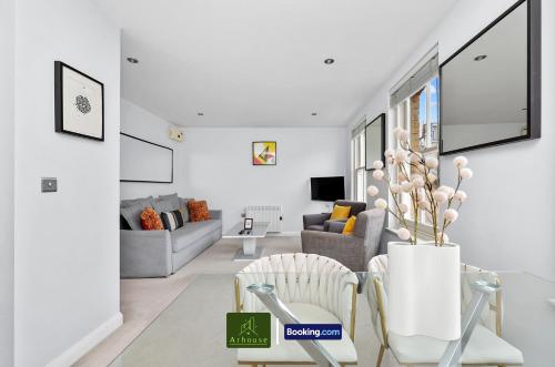 a white living room with a couch and chairs at Two Bedroom Apartment By Arhouse Apartments Short Lets & Serviced Accommodation Shoreditch With Free WiFi in London