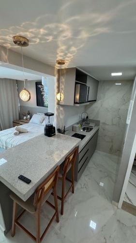 a kitchen with a table and a bed in a room at Flat luxury hotel cove in Maceió