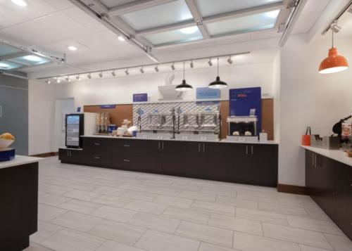 a large room with a counter in a kitchen at Holiday Inn Express & Suites - Detroit - Dearborn by IHG in Dearborn