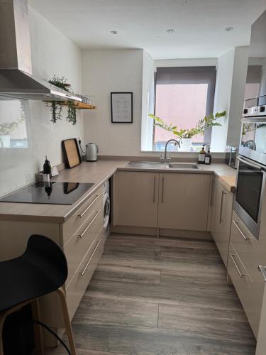 a kitchen with a sink and a stove top oven at The Crescent in Dundee