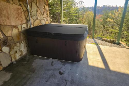 a large trash can sitting next to a stone wall at Serenity Now in New Tazewell