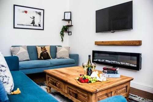 a living room with a blue couch and a table at Victoria Lodge in Haworth
