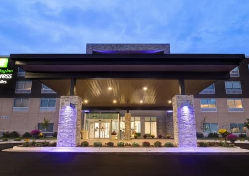 a building with a lit up front of it at Holiday Inn Express & Suites - Detroit - Dearborn by IHG in Dearborn