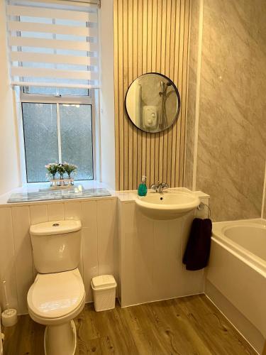 a bathroom with a toilet and a sink and a mirror at Central, Modern Apartment - Private Terrace - Dog Friendly in Aberdeen