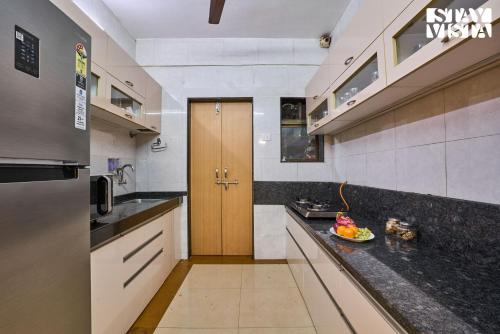 a kitchen with a bowl of fruit on the counter at StayVista at Solea with BBQ, Bonfire, AC in Panchgani