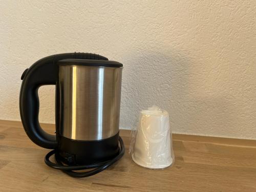 a coffee pot and a candle on a table at Hotel Drei Könige in Chur